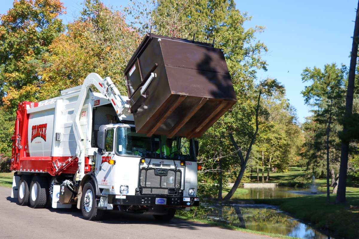 Rumpke Front Load Truck Picking Up Commercial Trash Dumpster