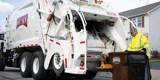 Rumpke Driver Emptying Residential Trash Into Trash Truck